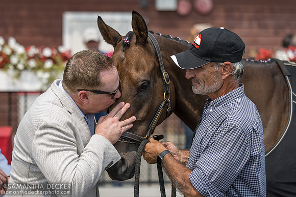 One of My Boy Tate's former owners, David Lyon, gives him a kiss, held by Rick Schosberg