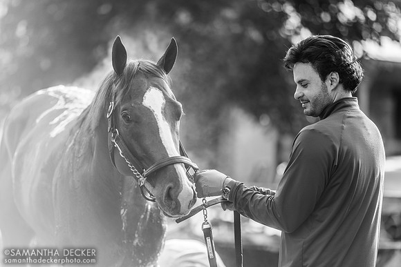Assistant trainer Gustavo Delgado, Jr. admires Mage while he gets s bath, 2023
