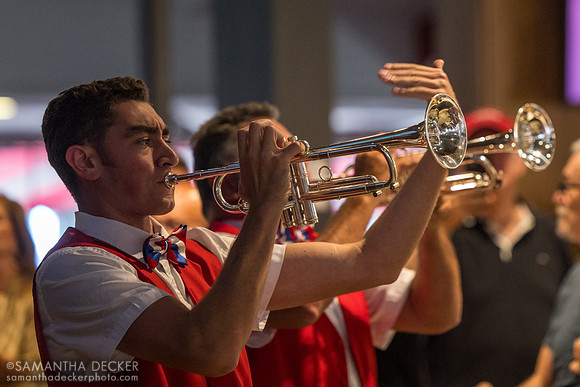 Bugler Carson Gambaro plays "God Bless the USA" with dad Tony by the Jim Dandy Bar