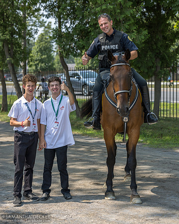 SSPD Officer Glen Barrett, aboard Apollo, poses with white caps Bryce Tuohy (left) and Regan Perella