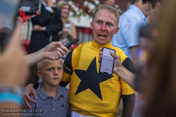 Dylan Davis talks to reporters with son Michael by his side