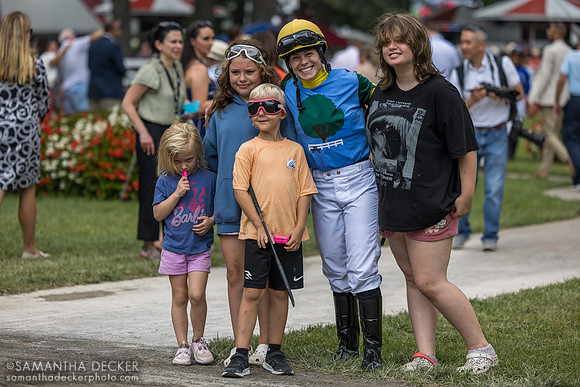 Jockey Katie Davis poses with friends and family in the paddock